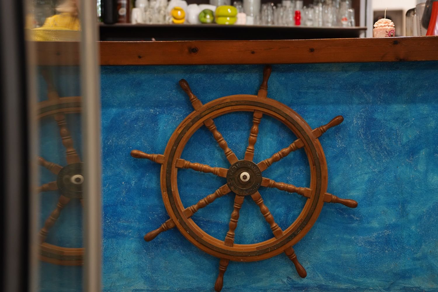 A ship's wheel on the wall inside Faros