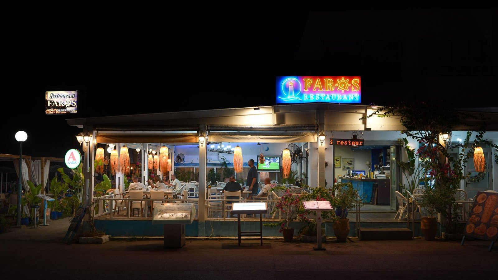Faros Restaurant lit up after dark
