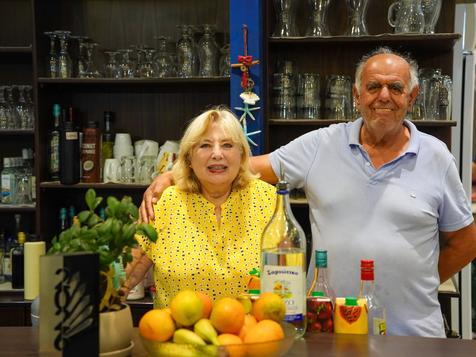 The owners of Faros behind the bar